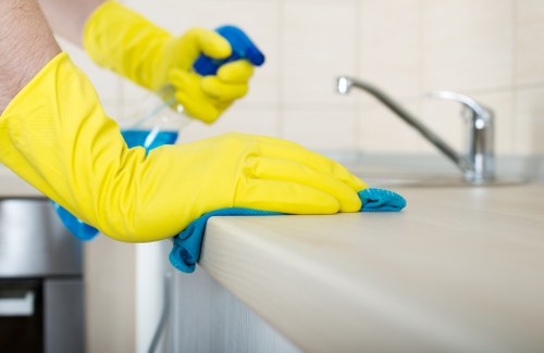 Deep cleaning in a TW1 bathroom focusing on taps, tiles, and fittings